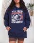 Man wearing a true-navy "Live Fast Eat Trash" hoodie with a retro graphic of a raccoon and opossum driving a car.